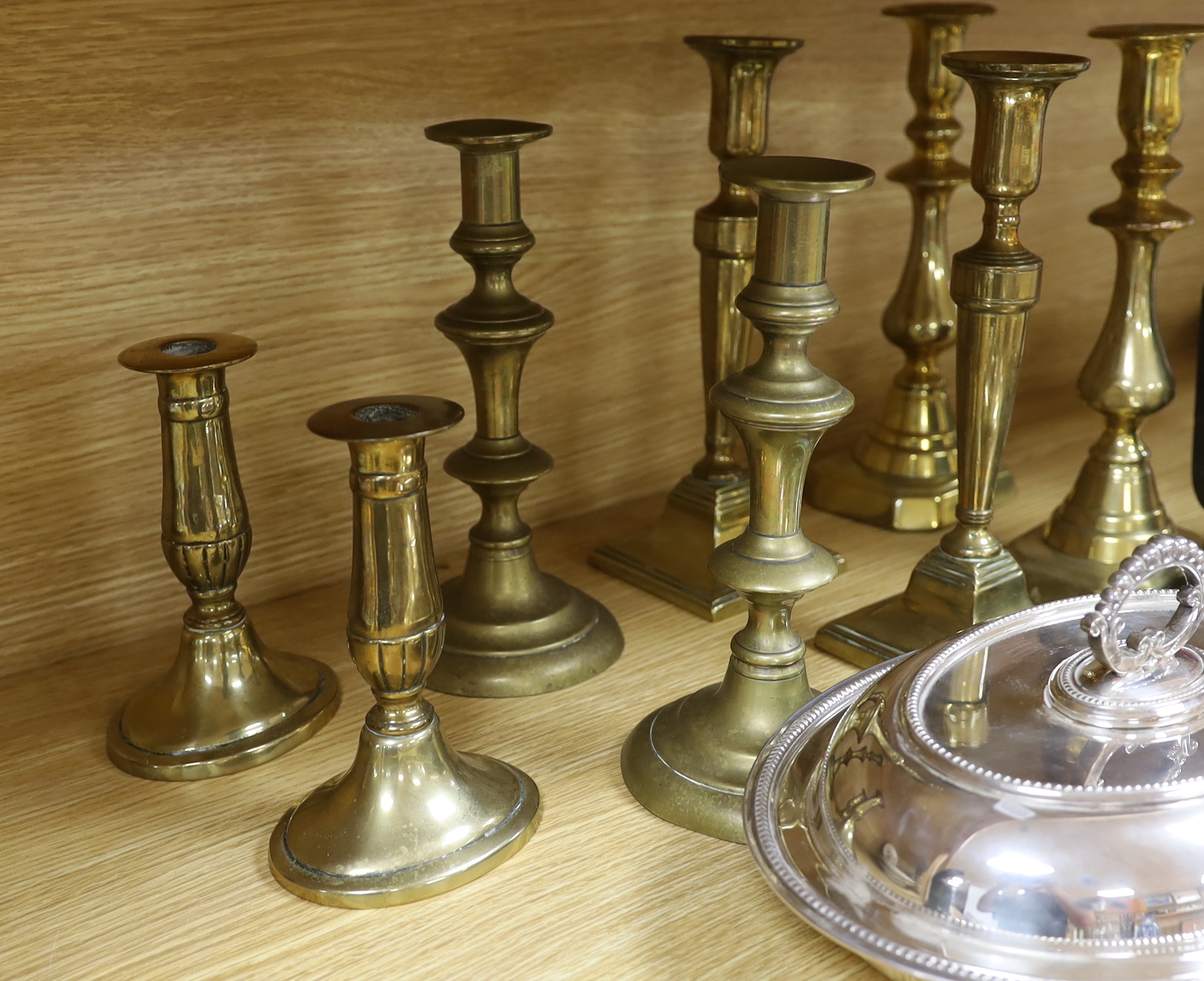 Four pairs of brass candlesticks, silver plated tureen and cover and a leather jewellery box with sundry collectibles